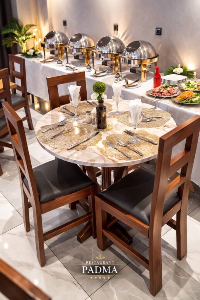 🍽️ Bienvenue au Restaurant Prestigieux PADMA – Nkolmbong Dans un cadre élégant, discret et chaleureux, le Restaurant PADMA vous accueille pour des moments d’exception au cœur de Nkolmbong. Lieu idéal pour vos anniversaires, mariages, réceptions privées, dîners d’affaires, réunions professionnelles et événements collectifs, notre restaurant offre un espace raffiné alliant calme, confort et ambiance conviviale. Notre équipe met à votre disposition un service soigné et personnalisé afin de faire de chaque événement une réussite. 🎉 Un espace adapté à tous vos événements Que ce soit pour : Anniversaires Mariages et fiançailles Réunions professionnelles Dîners d’entreprise Événements familiaux ou associatifs PADMA RESTAURANT vous garantit une organisation élégante dans un environnement sécurisé et confortable. 🍛 Une cuisine variée & raffinée Nous vous proposons une sélection de mets locaux et internationaux, préparés avec soin selon vos envies. Savourez également : Nos boissons naturelles Nos cocktails raffinés Nos vins variés Nos champagnes Nos whiskys de prestige 👉 Découvrez le détail complet de nos spécialités dans nos différentes pages : Menu Restaurant – Plats Menu Restaurant – Boissons 🍸 Snack Lounge & Hébergement Associé Profitez également de notre Snack Lounge, idéal pour vos moments de détente dans une ambiance moderne et conviviale. Et pour prolonger votre expérience, bénéficiez de notre hébergement PADMA HOTEL, avec des chambres VIP, VIP+ et Premium pour un confort optimal après vos événements. Au PADMA, chaque détail est pensé pour faire de votre passage une expérience mémorable. 📲 Réservation & Informations WhatsApp (Orange) : +237 693 56 31 81 📍 Pour nous localiser facilement, consultez le menu Contact sur notre site. 📲 Suivez-nous également sur Facebook et Instagram pour découvrir nos spécialités et événements exclusifs. PADMA RESTAURANT – Le goût d’en faire plus. ✨